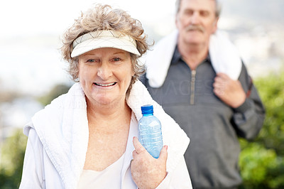 Smiling old woman with water and towel - Outdoor