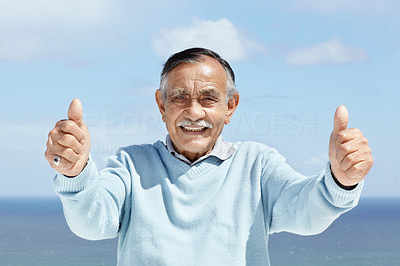 Happy mature man showing thumbs up sign
