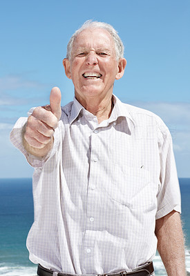 Excited old man showing thumbs up sign