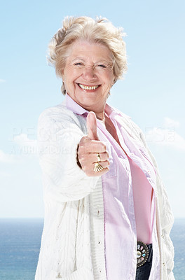 Happy old woman showing thumbs up sign