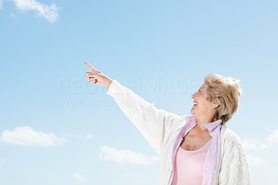 Lovely old woman pointing at copyspace - Outdoor