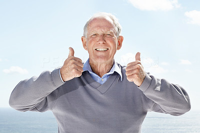 Confident old man showing thumbs up sign with both hands