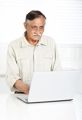 Relaxed senior man working on a laptop