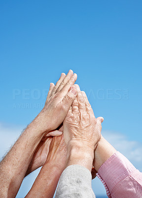 Unity - A group of hand raised against the sky