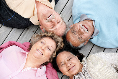 Portrait of a happy old people lying on wooden plank