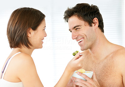 Lovely young couple enjoying meal in the kitchen