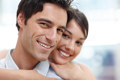 Closeup of a cute young couple together with arms around