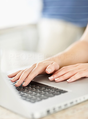 Cropped image of a woman using a laptop