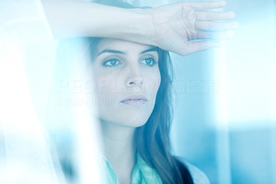 Cute young woman looking outside window