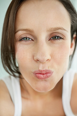 Closeup of a young woman offering you a kiss