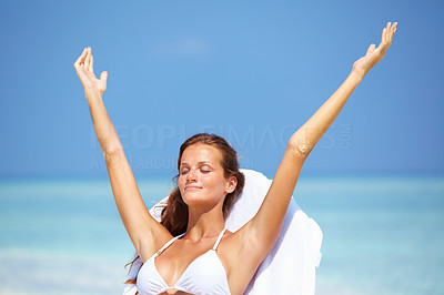 Relaxed woman with hands raised