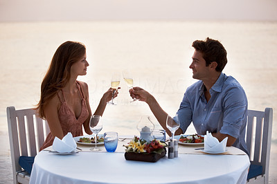 Romantic young couple having dinner in the beach