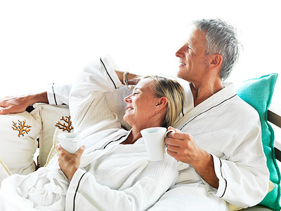 Lovely mature couple enjoying coffee in bedroom