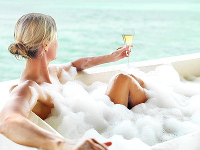 Luxurious lifestyle - Blond woman relaxing in bathtub