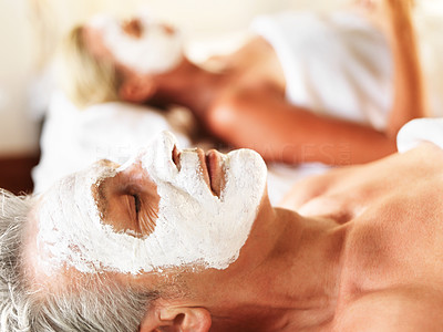 Mature man with face mask relaxing at spa