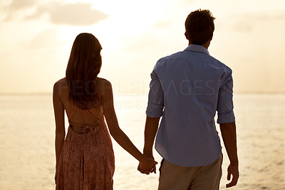 Romantic couple at the beach enjoying summer sunset