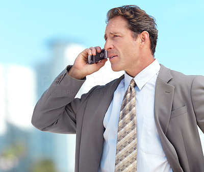 Business man talking on phone in the blue