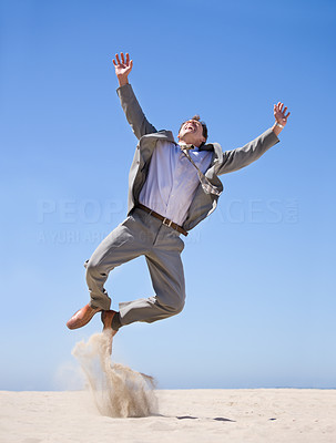 Businessman jumping in air, great success
