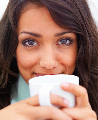 Closeup portrait of a beautiful young lady drinking coffee