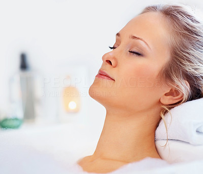 Portrait of a young woman relaxing in a bath tub