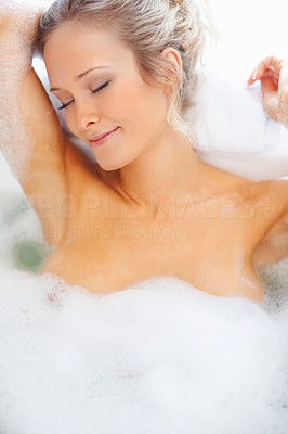 Female relaxing in a bath tub
