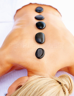 Top view closeup of a woman getting a stone massage therapy