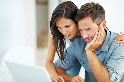 Couple browsing on laptop