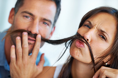 Couple imitating with fake mustache