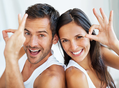 Couple giving ok gesture