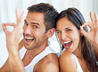 Couple showing ok gesture