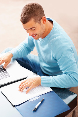 Young business man preparing a project report at home