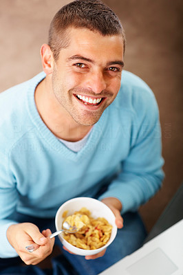 Happy young man eating cereal - Top view