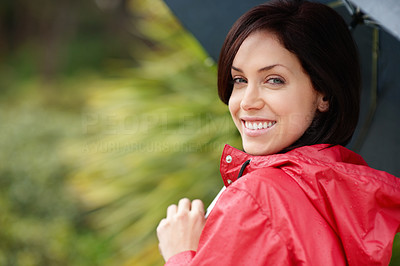Happy female in raincoat holding an umbrella