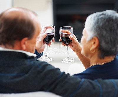 Rear view of an elderly couple having a glass of wine