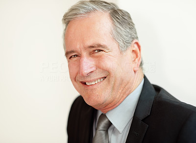 Closeup of a happy mature business man giving you a smile