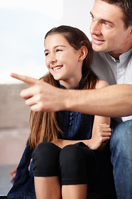 Father with his cute daughter pointing at something interesting