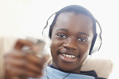 Closeup of a happy black boy listening to music on headphones