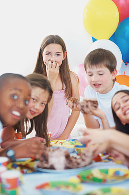 Cute little kids enjoying the birthday cake at a party