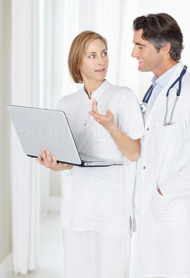 Doctor and nurse with laptop having a discussion