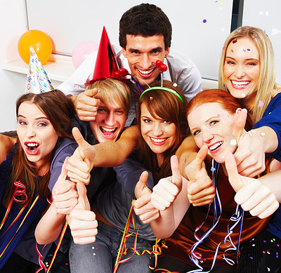 Youth showing thumbs up sign at a birthday party