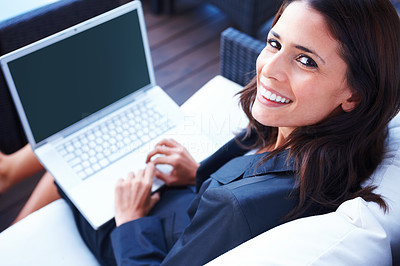 Top view of a beautiful woman sitting on a chair and using laptop