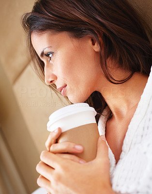 Closeup of a beautiful woman holding a paper cup