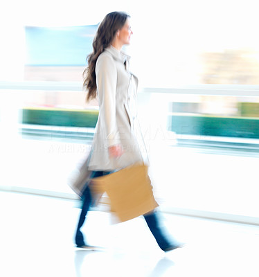 Woman walking in a shopping mall motion blur