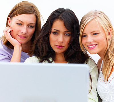 Pretty young women using laptop against white background