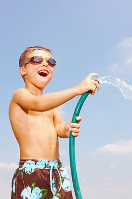 Happy young boy playing with water