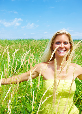 Portrait of a smiling young woman in field