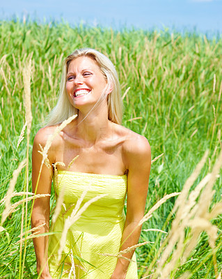 Beautiful young lady standing in field