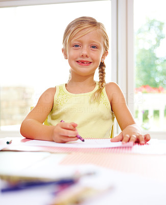 Portrait of a smiling girl drawing on paper