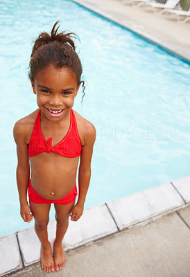 Girl in red bikini standing by the pool