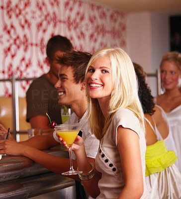 Young boys and girls enjoying drinks in bar
